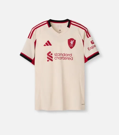 Flat lay photography of a cream soccer jersey with red accents on a white background.