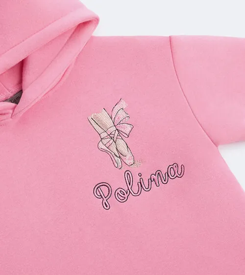 Flat lay detail photography showing embroidered logo on a pink children's hoodie photographed for e-commerce apparel photography.