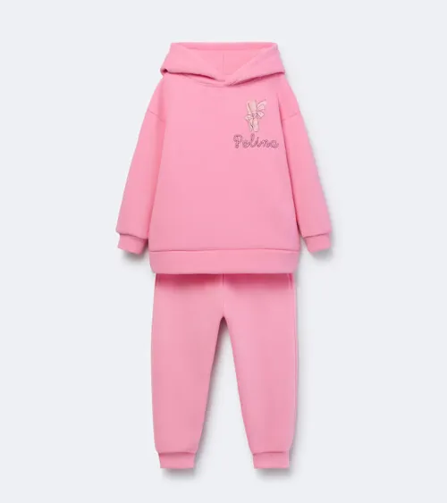 Flat lay photography of a pink children's hoodie and jogger set for online retail clothing photography.