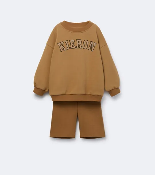 Flat lay photography of a tan children's sweatshirt and shorts set for children's apparel photography.