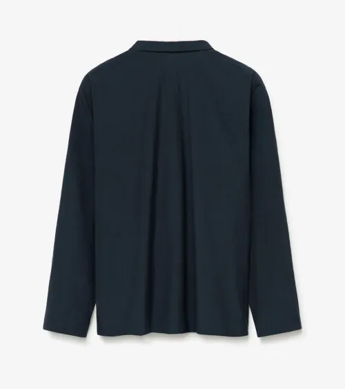 Flat lay photography showing the back view of a navy women's jacket for e-commerce apparel photography.