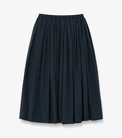 Flat lay photography of a navy gathered midi skirt, top-down view
