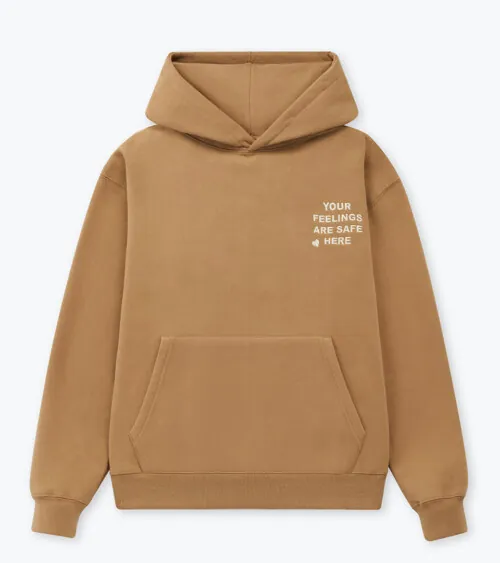 Flat lay photography of a tan pullover hoodie with front logo detail for online retail clothing photography.