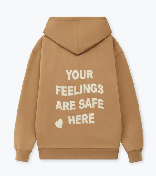 Flat lay photography of a tan hoodie back view with printed slogan text