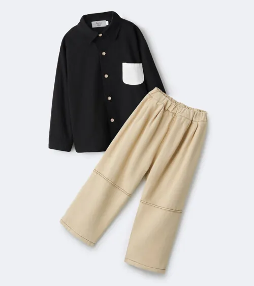 Flat lay photography of a kids outfit set with a black button shirt and beige pants