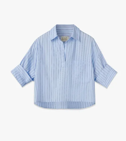 Flat lay photography of a blue striped women's blouse for fashion e-commerce photography.