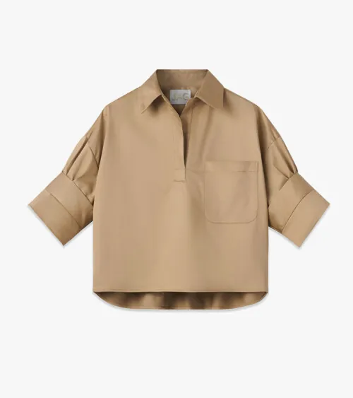 Flat lay photography of a beige women's short-sleeve blouse photographed for online retail apparel photography.