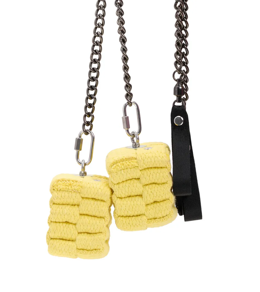 Product photography of yellow woven charms on silver chains with black clips
