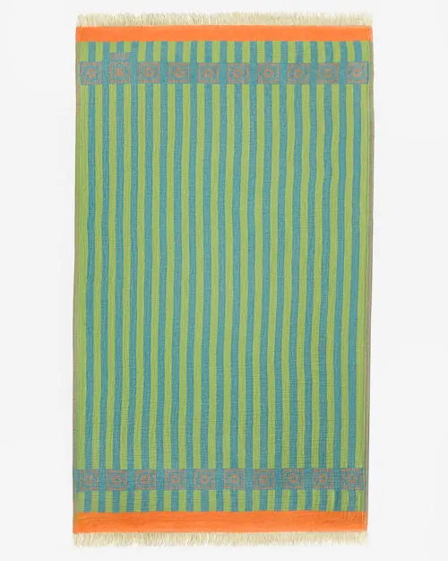 Flat lay photography of a green and blue striped towel with an orange border and fringed ends, shown full length