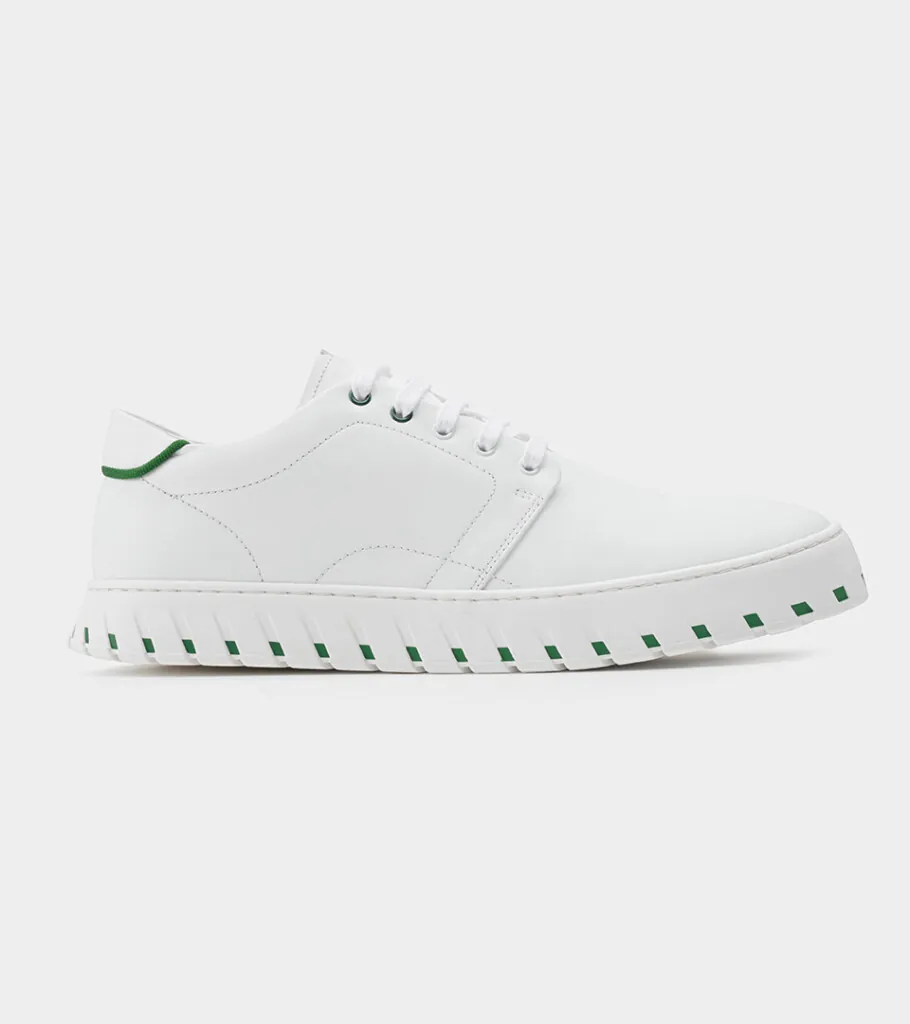 Shoe product photography of a white leather sneaker in side profile with a white ridged platform sole