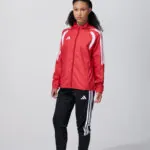 Female model in red adidas track jacket and pants