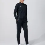 Male model in black Nike track jacket and pants