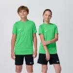 Two youth models in matching green Nike soccer jerseys