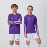 Two youth models in matching purple Nike goalkeeper jerseys