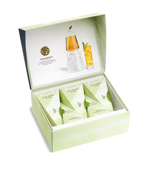 Professional product photography featuring a Tea Forte wellness gift set with premium tea sachets and tea bottle, photographed for an online store.